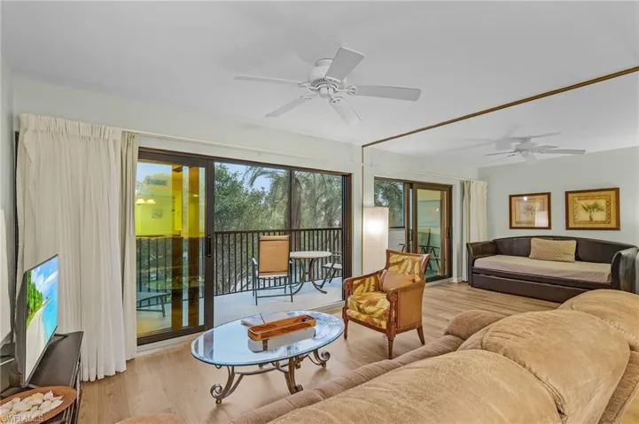 Living room featuring ceiling fan and light hardwood / wood-style flooring