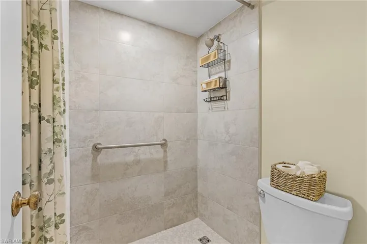 Bathroom with toilet and tiled shower