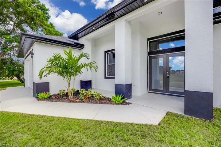 Doorway to property with a yard and french doors