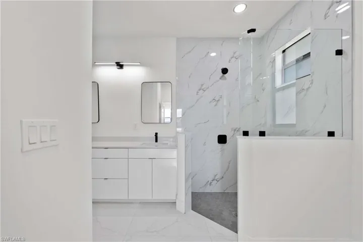 Bathroom with a tile shower and vanity