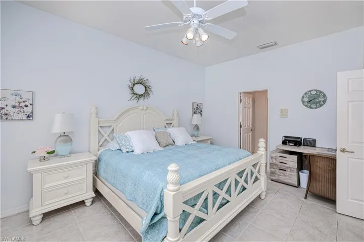 Bedroom featuring ceiling fan and light tile floors