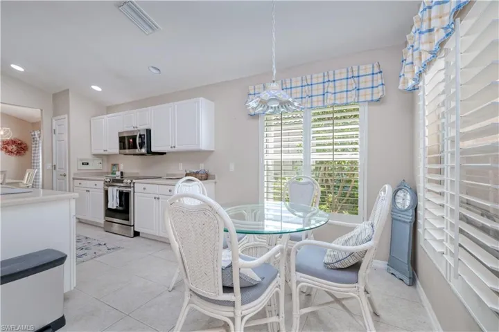Dining area featuring sink and light tile floors