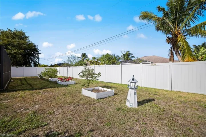 View of yard with a garden and a fenced backyard