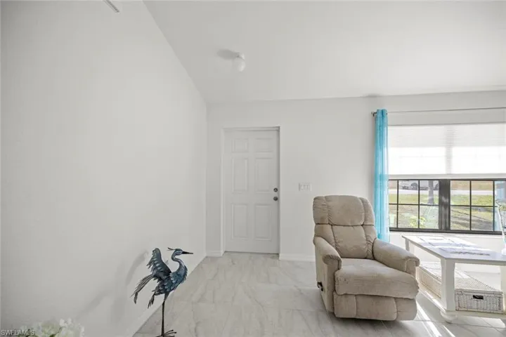 Living area with marble finish floor and baseboards