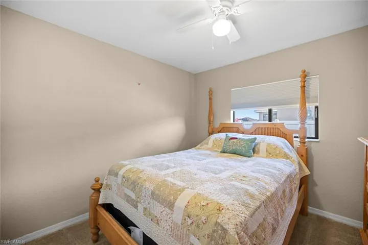 Bedroom featuring carpet flooring, baseboards, and a ceiling fan