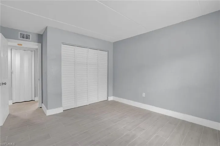 Unfurnished bedroom featuring a closet and light hardwood / wood-style floors