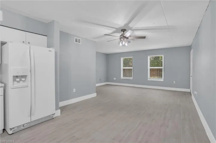 Unfurnished room featuring ceiling fan and light wood-type flooring