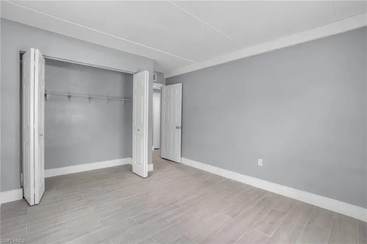 Unfurnished bedroom with a closet and light hardwood / wood-style floors