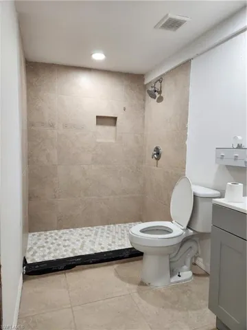 Office Bathroom featuring vanity, tiled shower, and recessed lighting - Pic 4
