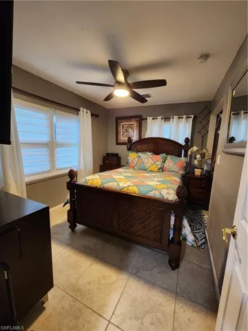 Main Bedroom with light tile and ceiling fan - Pic 1
