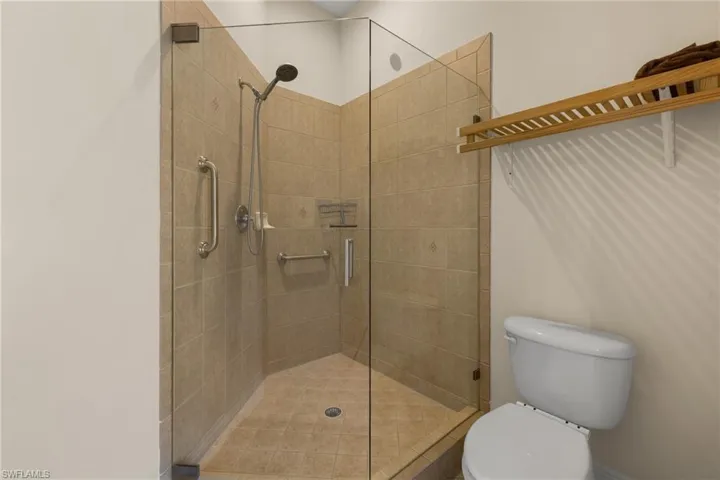 Primary Bath separate shower and toilet, features a new glassed walk-in shower.