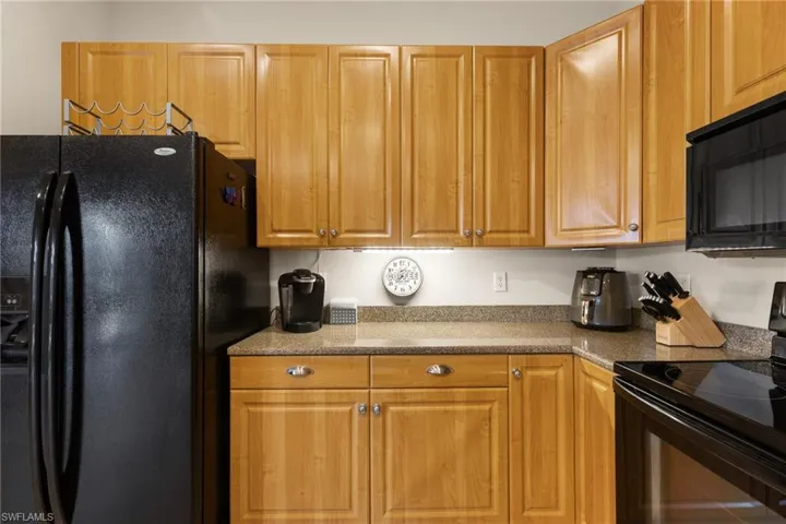 Closeup of kitchen cabinetry, countertops, appliances.