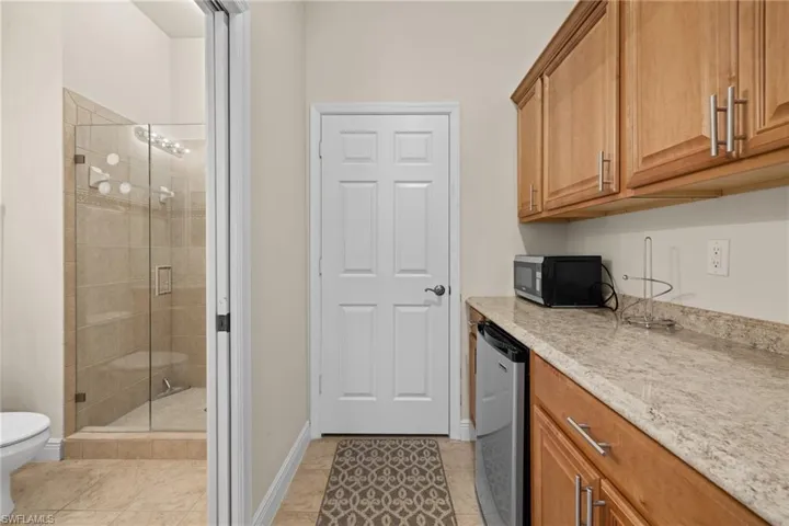 Cabana kitchenette with cabinetry, counterspace, refrigerator and microwave.