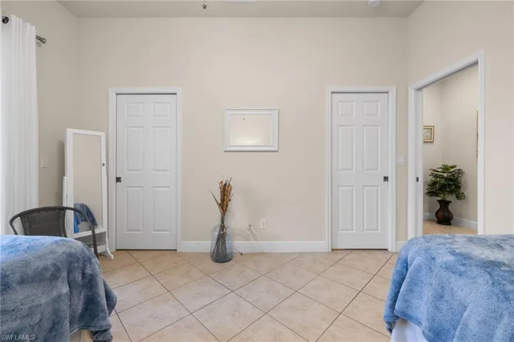 Guest bedroom with walk-in closet and convenient pocket door entry to guest bath.