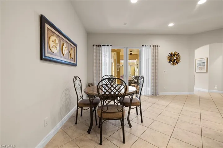 In kitchen dining area looking through sliding doors onto courtyard.