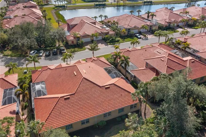 Aerial view featuring a lovely street with lake. Plenty of lovely walking, biking areas.