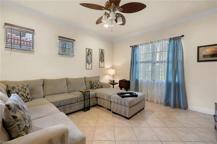 The Sizable Great Room features tile flooring, windows, treatments, and looks onto the Preserve.