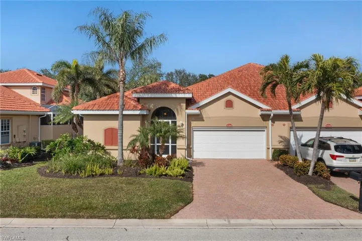Courtyard Villa Home street view. Notice pavers on drive, 2 car garage, entry foyer and community landscaping.