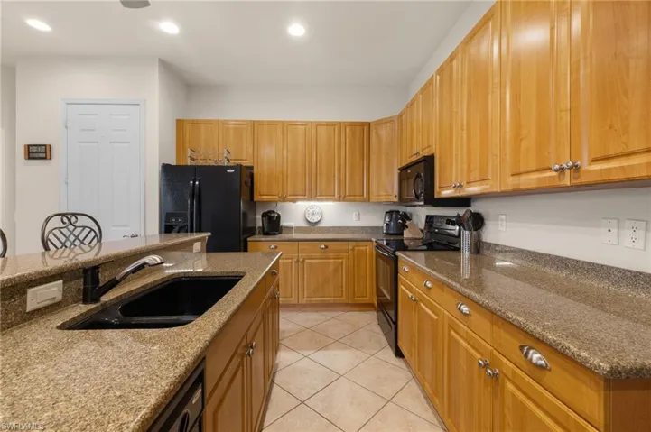 Another perspective of the kitchen area. Island, counterspace, appliances.