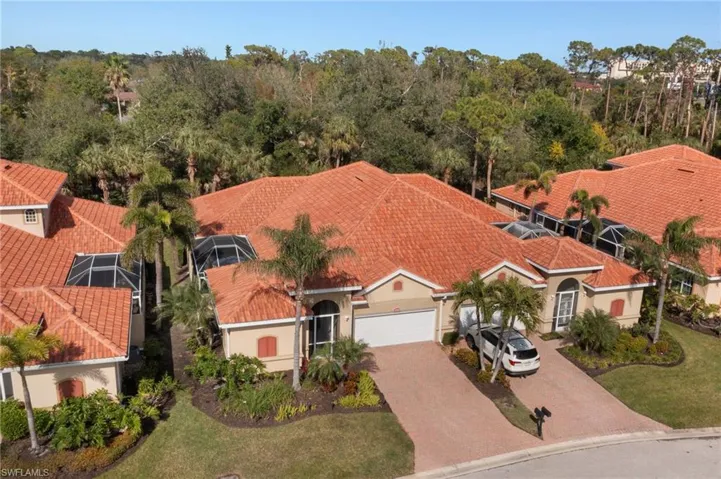 Aerial view of Villa from street view. Preserve to rear, landscaping and extra guest parking in front.