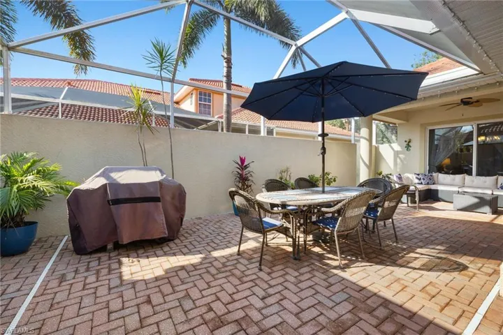 Private courtyard showing how open and refreshing this screened covered area is. Webber Grill, Table with umbrella and seating for 6.