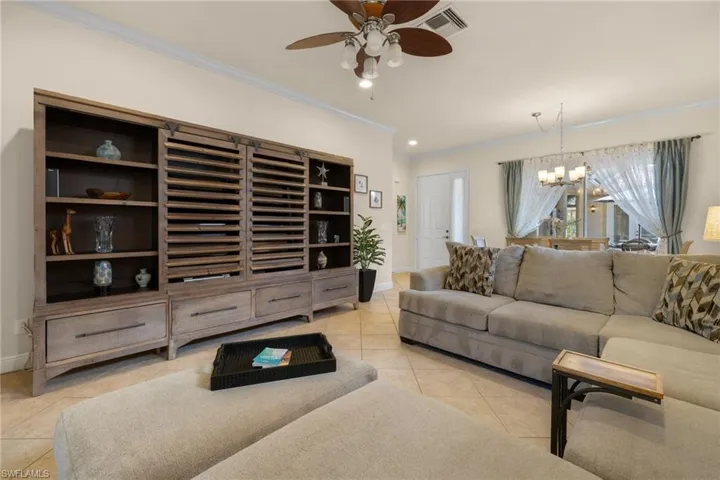 Great room showing comfy furnishings looking onto courtyard and dining area.