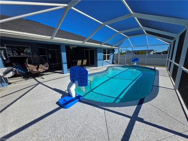 View of pool with a sunroom, a lanai, and a patio area