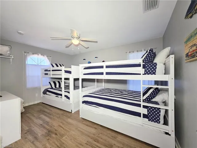 Bedroom with wood finished floors and ceiling fan