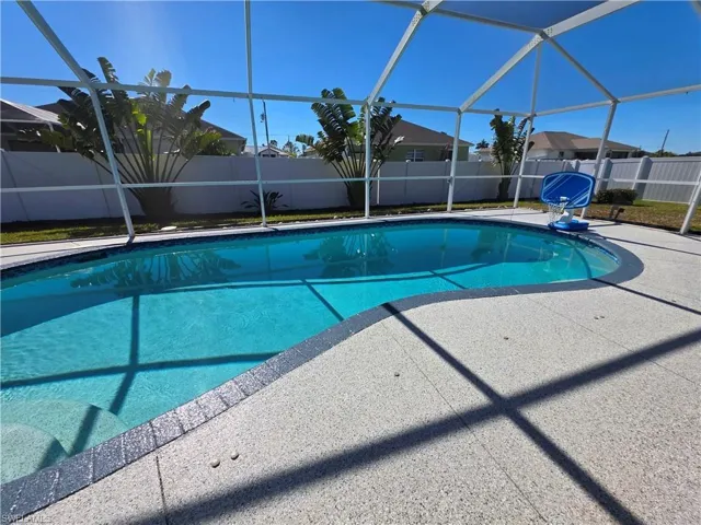 View of swimming pool featuring a lanai, a sunroom, a fenced backyard, and a patio area