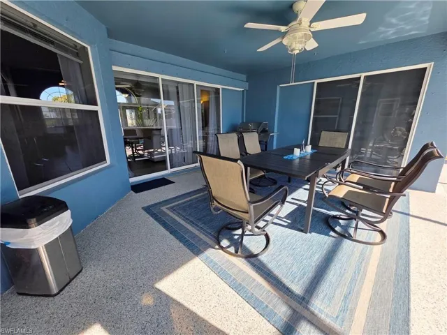 View of patio / terrace with outdoor dining area, a ceiling fan, and area for grilling