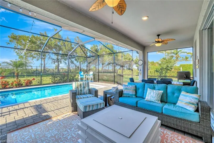View of patio featuring an outdoor pool, ceiling fan, an outdoor hangout area, and a lanai