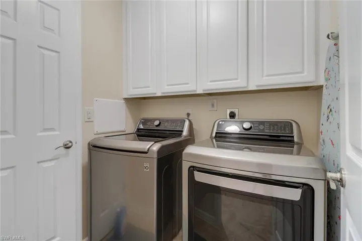 Laundry room with cabinet space and washer and clothes dryer