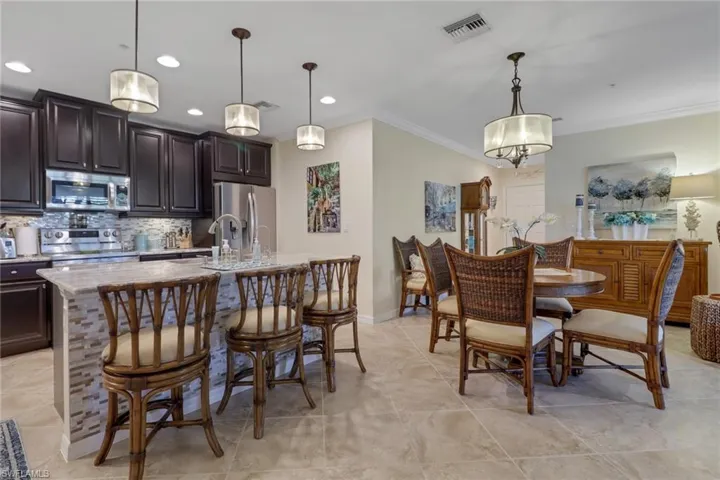 Dining room featuring baseboards, visible vents, recessed lighting, and ornamental molding