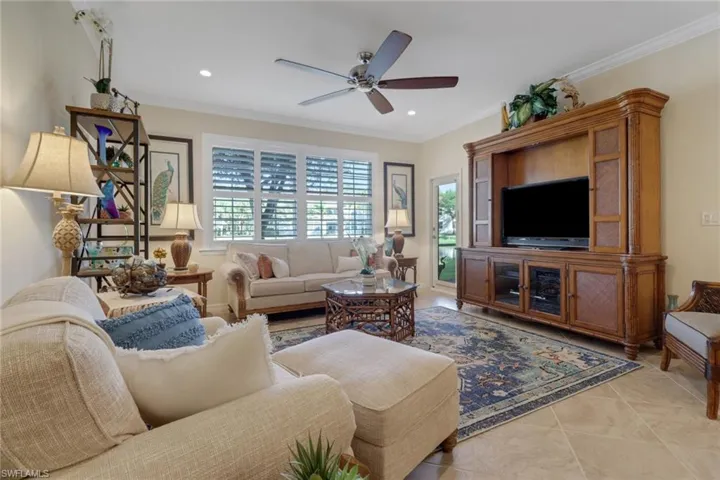Living room with a ceiling fan, plenty of natural light, crown molding, and recessed lighting