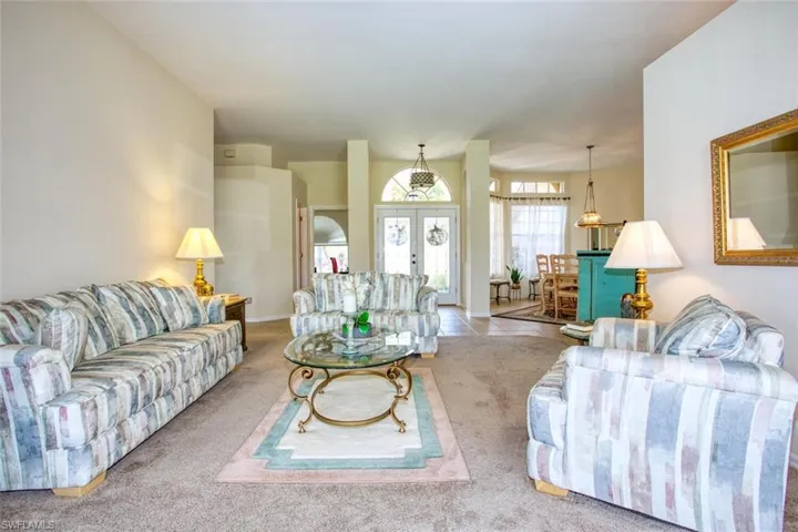 Living room featuring sliding glass doors and light carpet