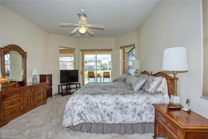 Bedroom with light carpet, access to outside via sliding glass doors