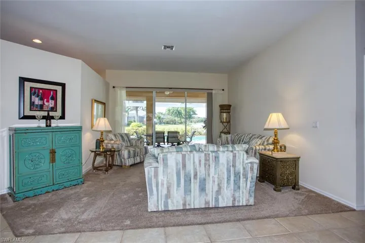Living room featuring neutral tile floors