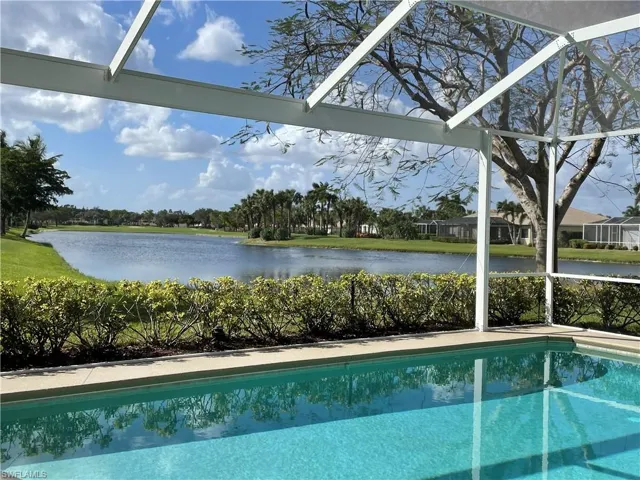 View of swimming pool featuring a water view and a lanai