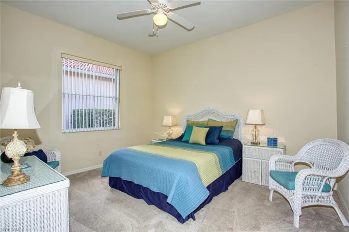 Bedroom featuring light carpet and ceiling fan