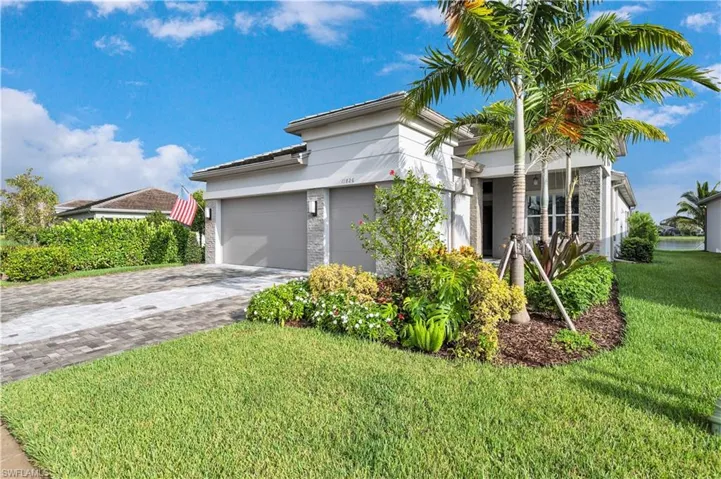 View of front of property with a garage and a front yard