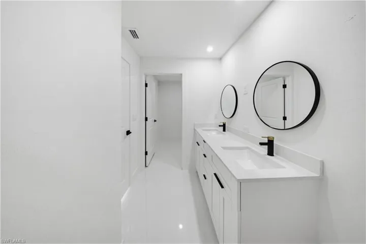 Full bath with double vanity and recessed lighting