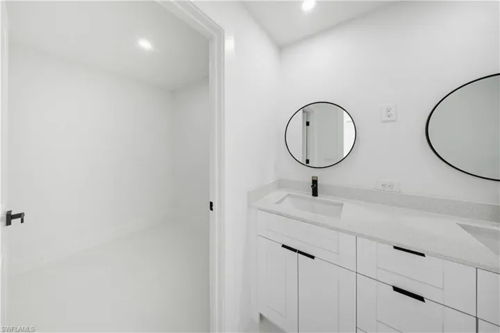 Bathroom featuring double vanity and recessed lighting