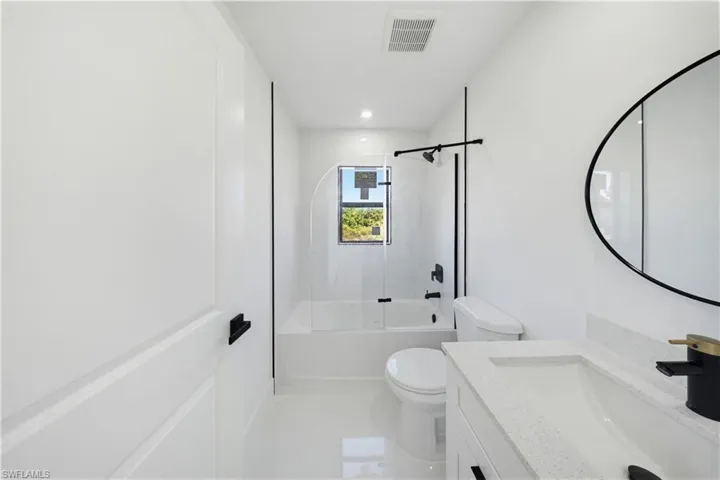 Bathroom featuring shower / bathtub combination, vanity, and recessed lighting