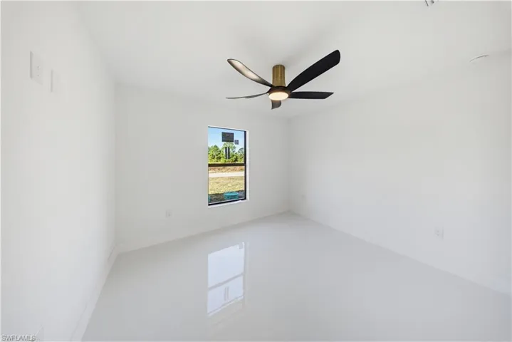 Unfurnished room featuring a ceiling fan