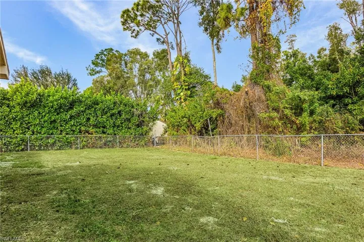 Fenced in yard, May 2024, offers an abundance of space for all your needs.
