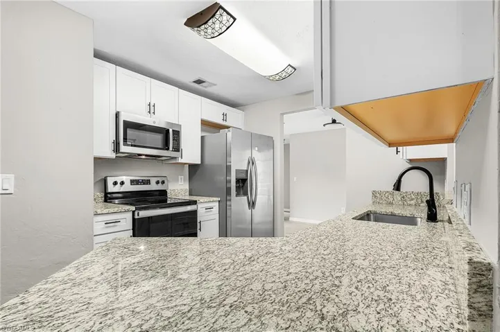 Kitchen offers granite counter, stainless appliances and easy access to the dining area.