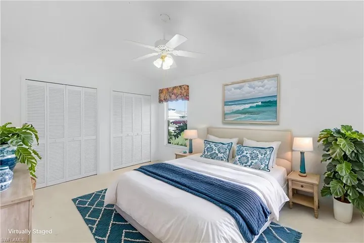 Virtually staged Bedroom featuring two closets and a ceiling fan