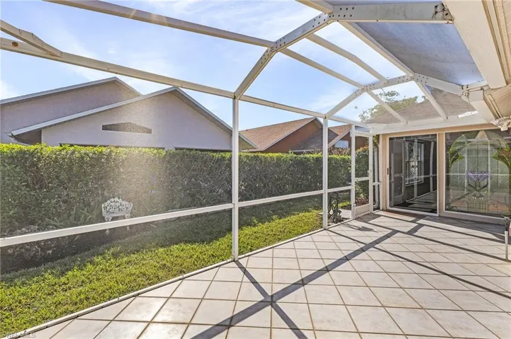 Unfurnished sunroom featuring a patio area