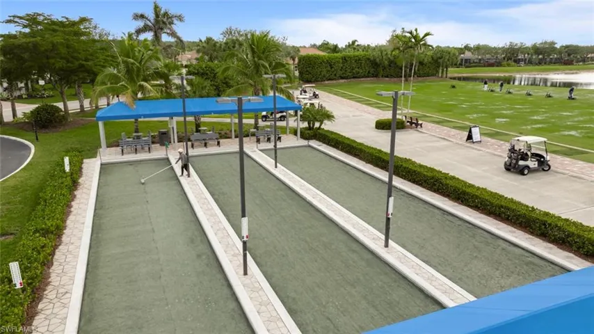View of home's community featuring a water view and a lawn