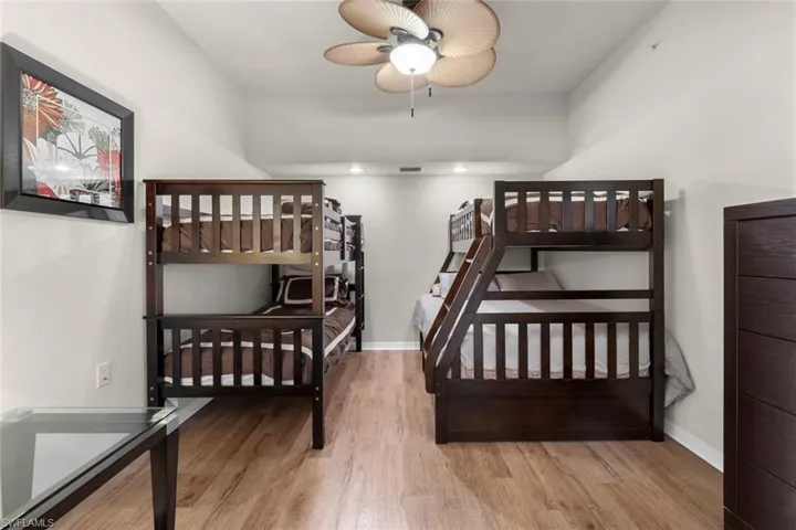 Bedroom featuring ceiling fan and wood-type flooring